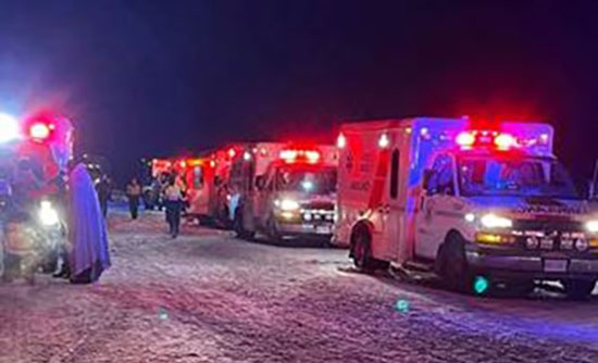 ambulances responding to a bus crash on a snowy highway
