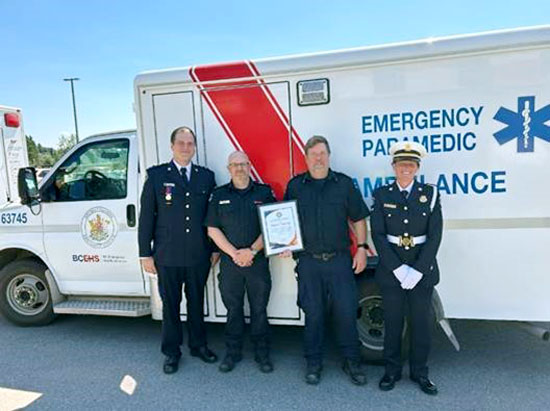 Drew Patton receiving his commendation at Station 753 in Burns Lake