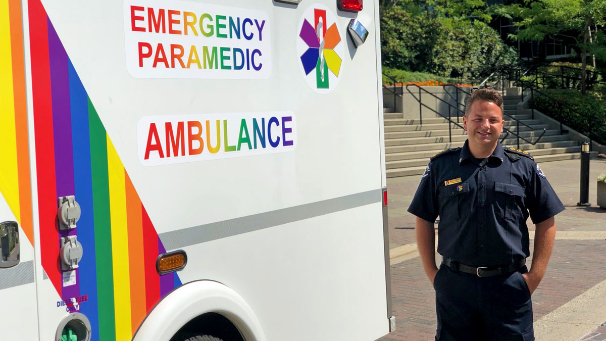 Clinical Operations Manager Nicholas (Nick) Mann with the first Pride wrapped ambulance