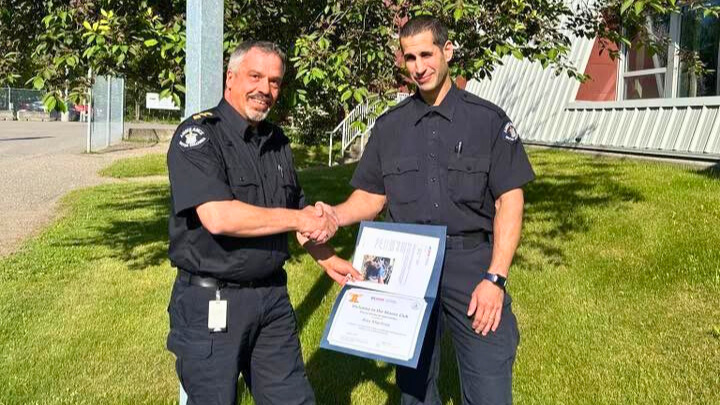 Darren Waller on left presenting Alex Maritsas with certificate