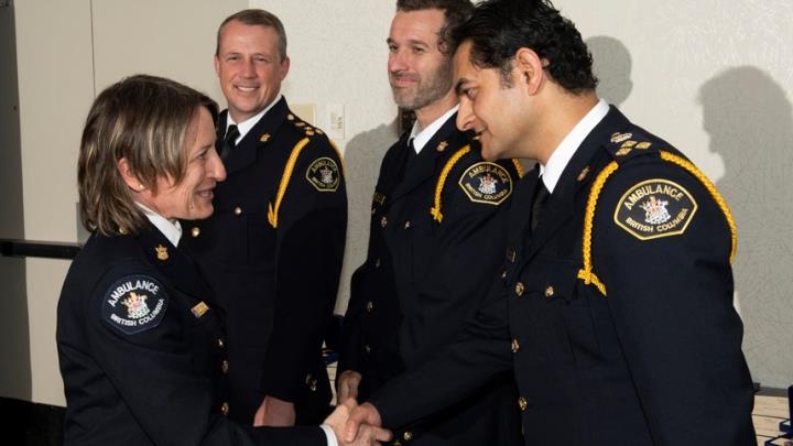 Paramedic specialist Jennie Helmer is congratulated by Amit Sobti, Executive Director of Provincial Programs at BCEHS