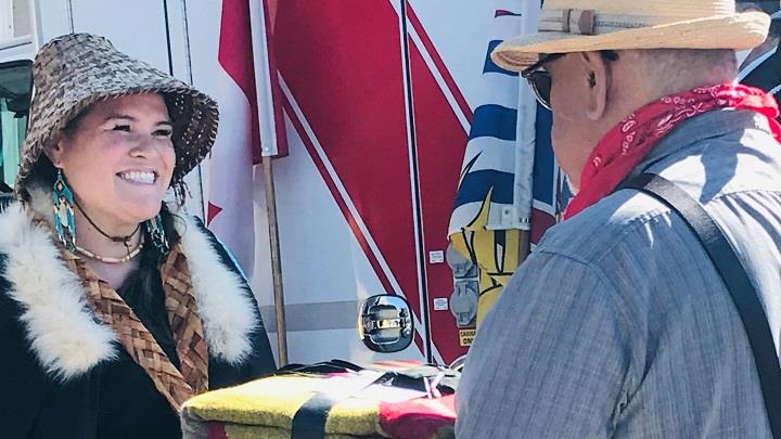 Indigenous woman smiles during a ceremony at Vancouver's Downtown Eastside ambulance station for Indigenous People's Day