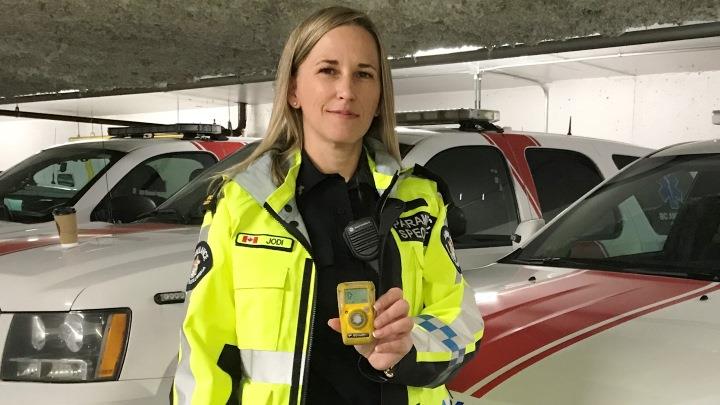 Paramedic specialist Jodi Butterman holds up a portable carbon monoxide monitor