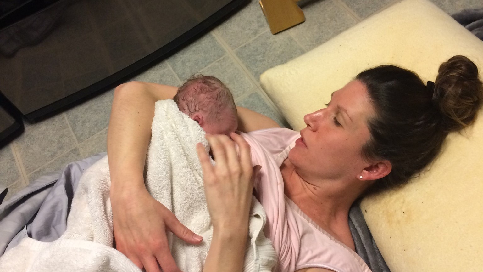 Elaine Tuit and her new baby Hailie on the laundry room floor