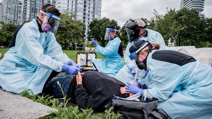 Paramedics treat a patient who has overdosed