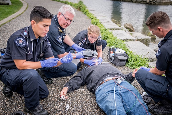 Paramedics treat a patient who has overdosed