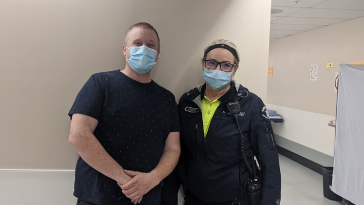 Social worker and paramedic smiling while wearing masks