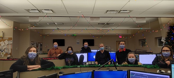 Dispatch Centre staff posing in front of monitors