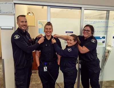 Four smiling dispatchers in uniform