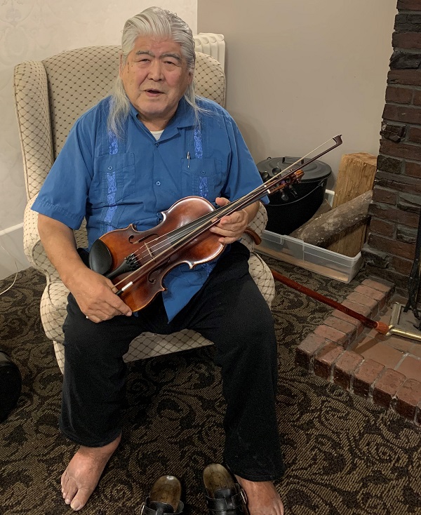 Wally Firth with his violin and new bow at his independent living home in Victoria