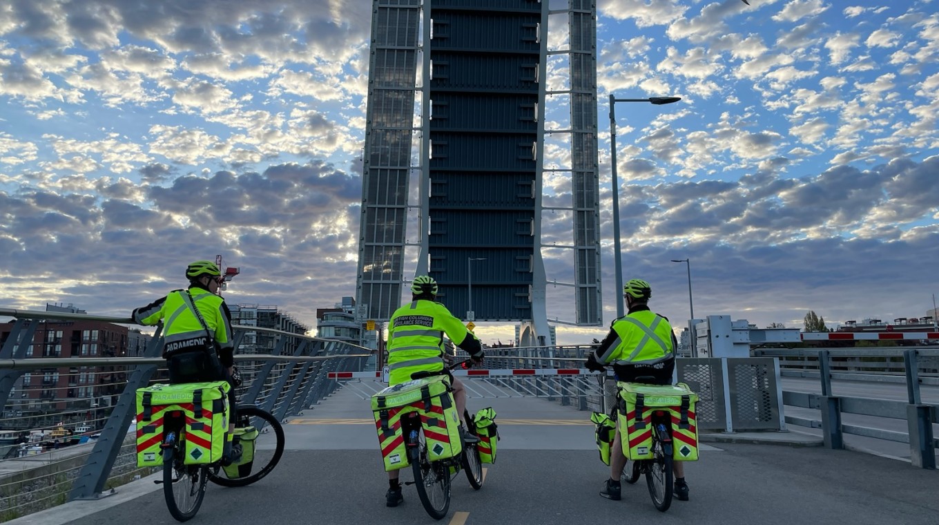 three bike squad paramedics looking at the raised Johnson Street bridge in Victoria